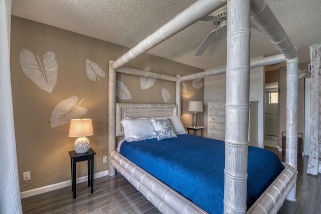 bedroom with dark hardwood / wood-style floors and a textured ceiling