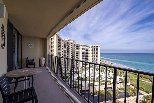 balcony featuring a water view and a view of the beach