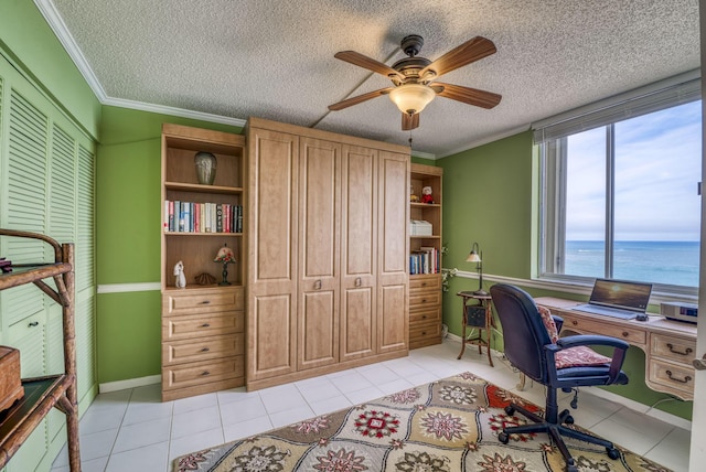 tiled office space with ceiling fan, ornamental molding, a textured ceiling, and a water view