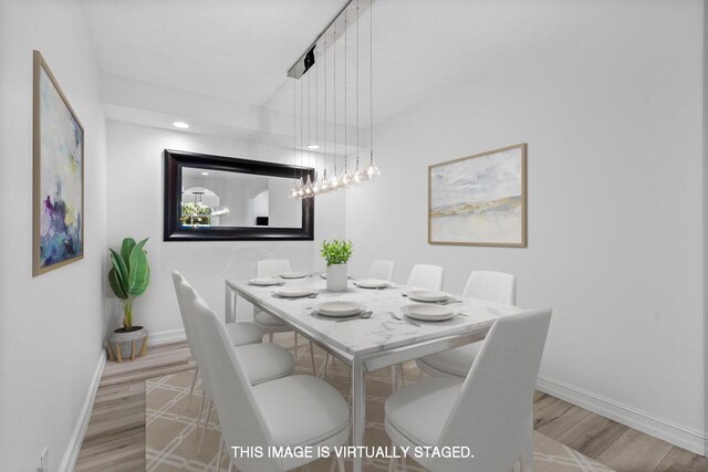 spare room featuring recessed lighting, light wood-style flooring, and baseboards