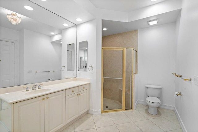 bathroom featuring tile patterned flooring, vanity, toilet, and walk in shower