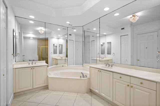 bathroom featuring a closet, a stall shower, a sink, and tile patterned floors