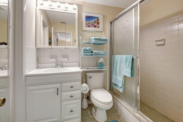 bathroom with tile walls, backsplash, vanity, toilet, and walk in shower