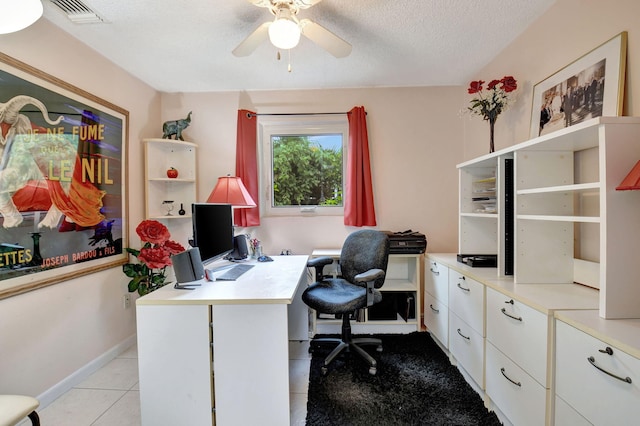 office area with ceiling fan, a textured ceiling, and light tile patterned floors