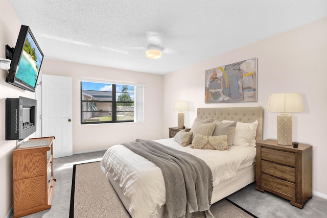 carpeted bedroom with baseboards and a textured ceiling