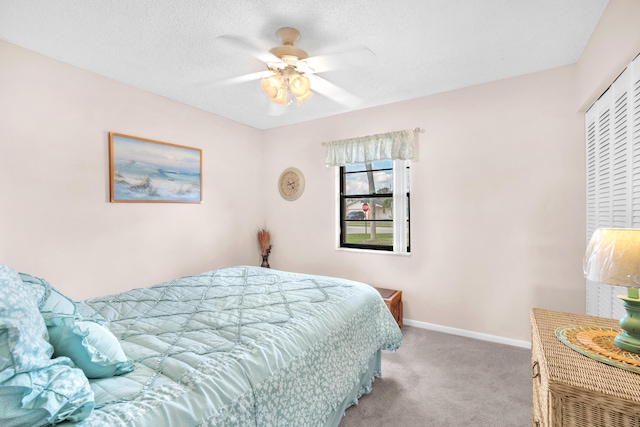 bedroom with carpet, baseboards, a closet, and ceiling fan