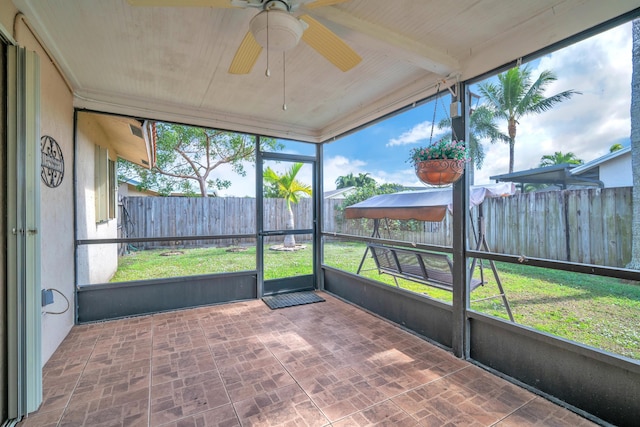 sunroom / solarium with plenty of natural light and ceiling fan