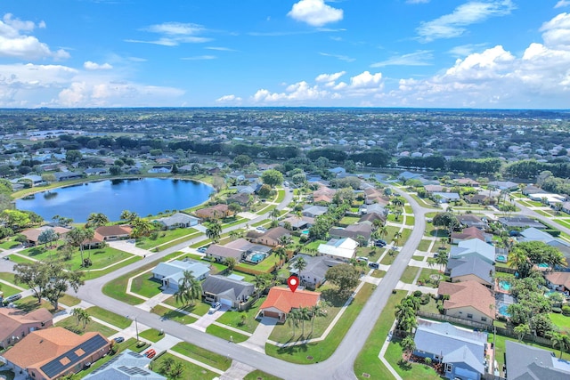 drone / aerial view with a residential view and a water view