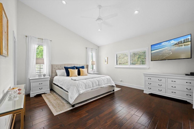 bedroom featuring dark wood-style floors, multiple windows, vaulted ceiling, and ceiling fan