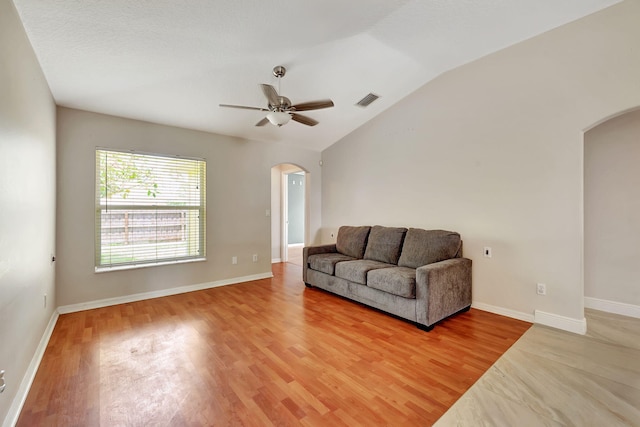 living room featuring lofted ceiling, wood-type flooring, and ceiling fan