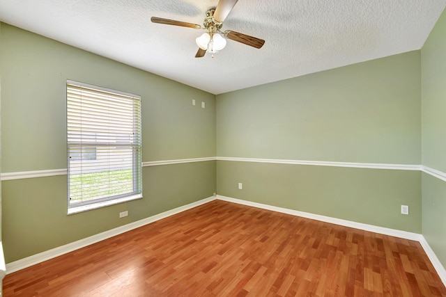 empty room featuring hardwood / wood-style floors, a textured ceiling, and ceiling fan