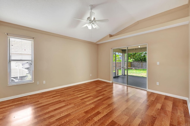 empty room featuring ceiling fan, lofted ceiling, and light wood-type flooring