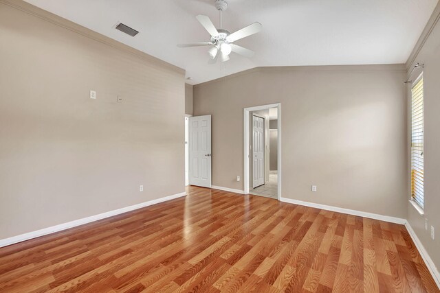 unfurnished room with vaulted ceiling, ornamental molding, ceiling fan, and light hardwood / wood-style floors