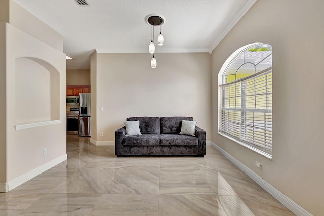 sitting room with ornamental molding and a textured ceiling