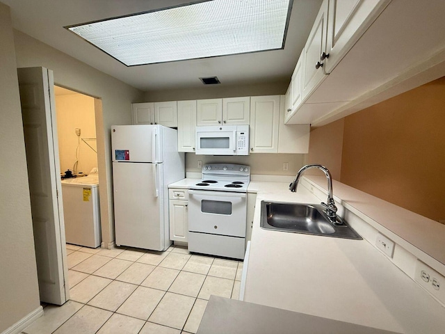 kitchen featuring white cabinetry, sink, white appliances, and light tile patterned floors