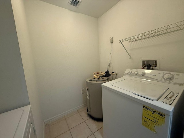 laundry room featuring light tile patterned flooring and separate washer and dryer