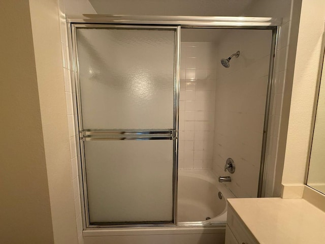 bathroom featuring vanity and bath / shower combo with glass door