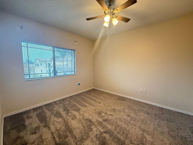 carpeted spare room featuring ceiling fan and a textured ceiling