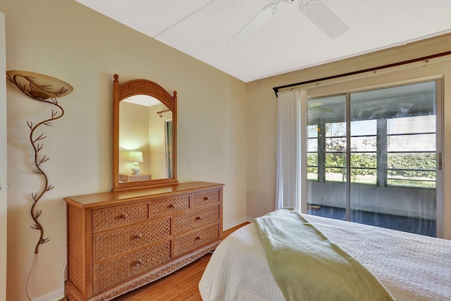 bedroom with wood-type flooring, access to exterior, and ceiling fan