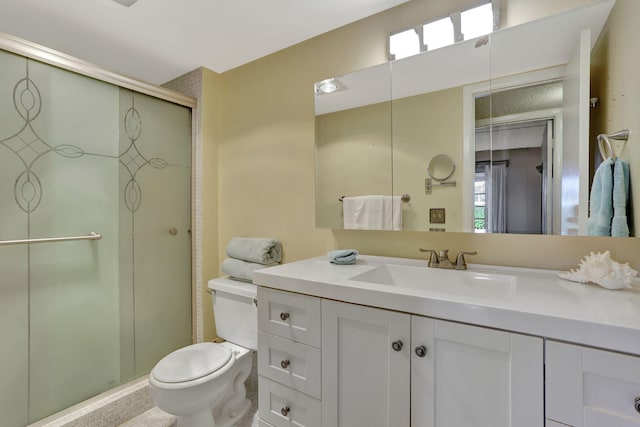 bathroom with walk in shower, vanity, and toilet