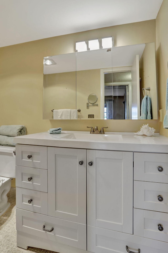 bathroom featuring vanity and toilet