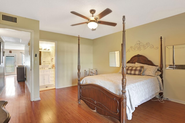 bedroom featuring wood-type flooring, ceiling fan, and ensuite bath