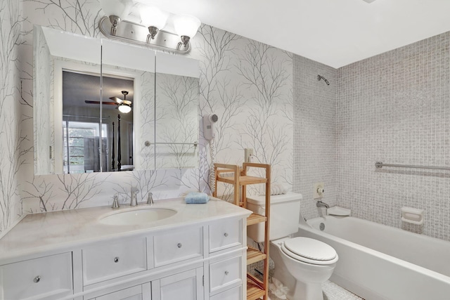 full bathroom with vanity, ceiling fan, tiled shower / bath combo, and toilet