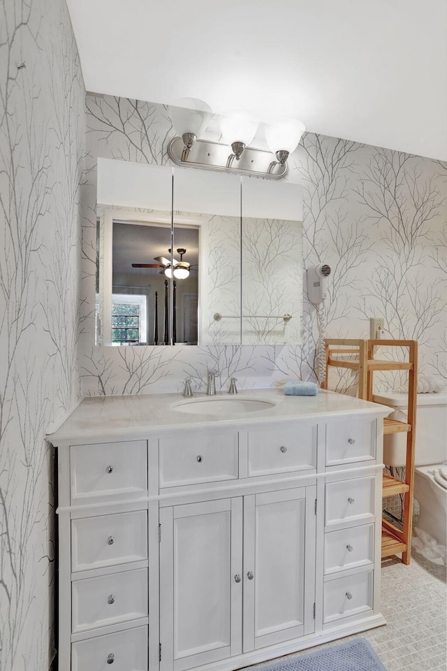 bathroom with ceiling fan and vanity