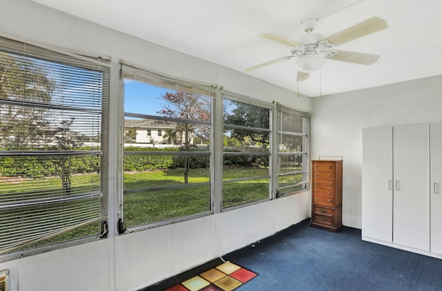 unfurnished sunroom with a wealth of natural light and ceiling fan