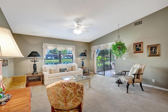 carpeted living room featuring ceiling fan, lofted ceiling, and plenty of natural light