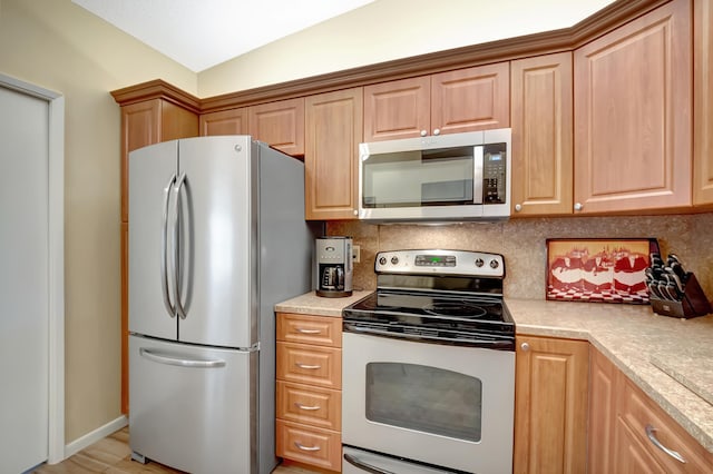 kitchen featuring decorative backsplash and appliances with stainless steel finishes