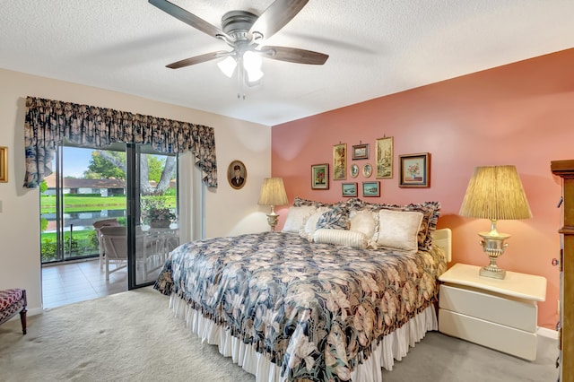 carpeted bedroom with ceiling fan, a textured ceiling, and access to outside