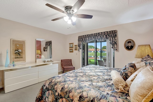 carpeted bedroom featuring ceiling fan, a textured ceiling, and access to outside