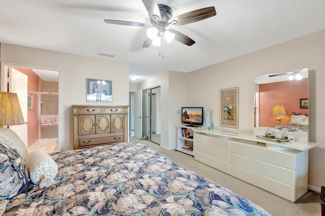 bedroom featuring ceiling fan, a closet, and a textured ceiling