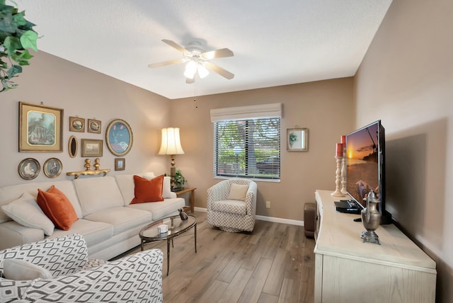 living room featuring hardwood / wood-style floors, a textured ceiling, and ceiling fan