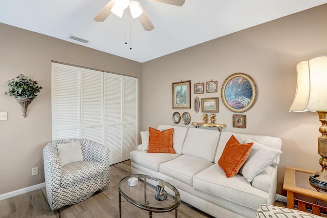 living room featuring ceiling fan and wood-type flooring