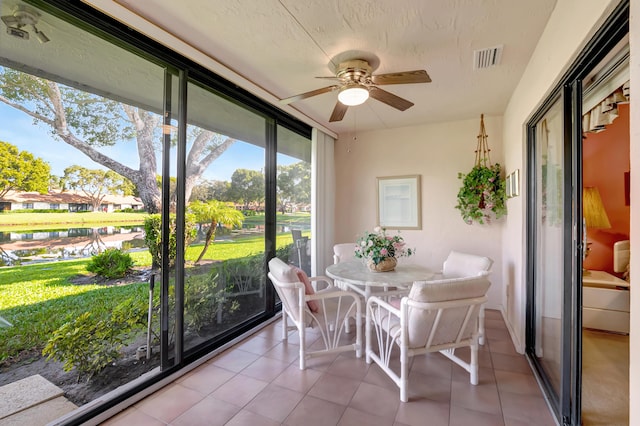 sunroom / solarium featuring ceiling fan