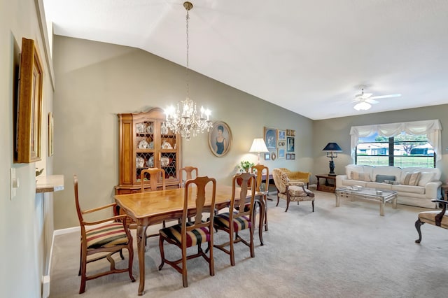 carpeted dining area with lofted ceiling and ceiling fan with notable chandelier