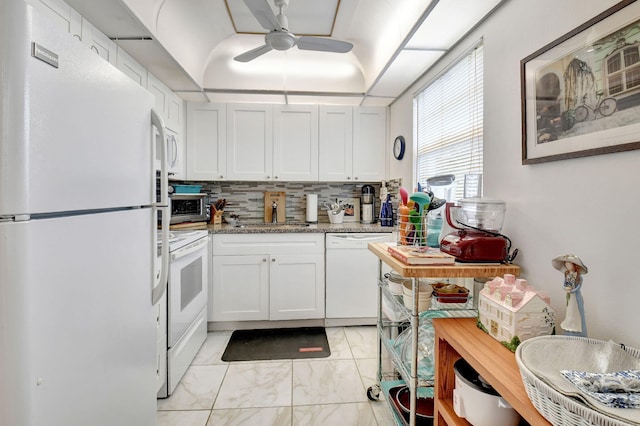 kitchen with sink, white cabinetry, ceiling fan, stone counters, and white appliances