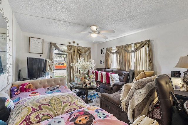 interior space featuring ceiling fan, access to exterior, and a textured ceiling