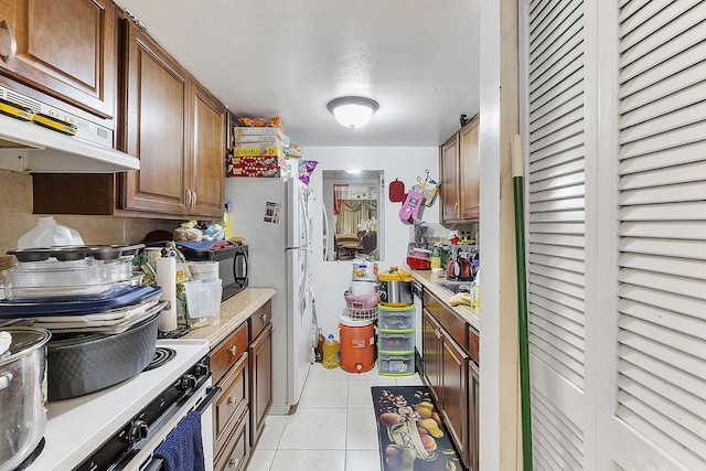 kitchen featuring white appliances and light tile patterned flooring