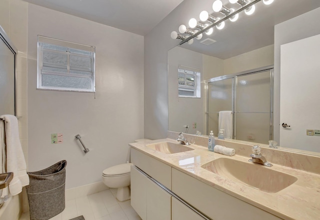 bathroom with vanity, tile patterned flooring, a shower with door, and toilet