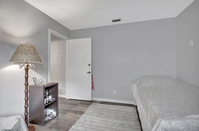 bedroom with hardwood / wood-style flooring