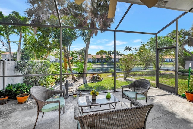 sunroom / solarium featuring a water view