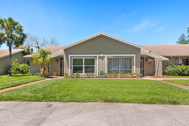 ranch-style house featuring a front lawn