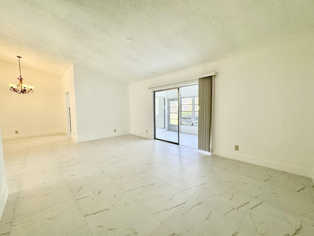 empty room featuring an inviting chandelier, lofted ceiling, and a textured ceiling