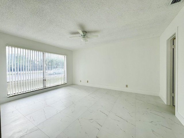 empty room featuring a textured ceiling and ceiling fan