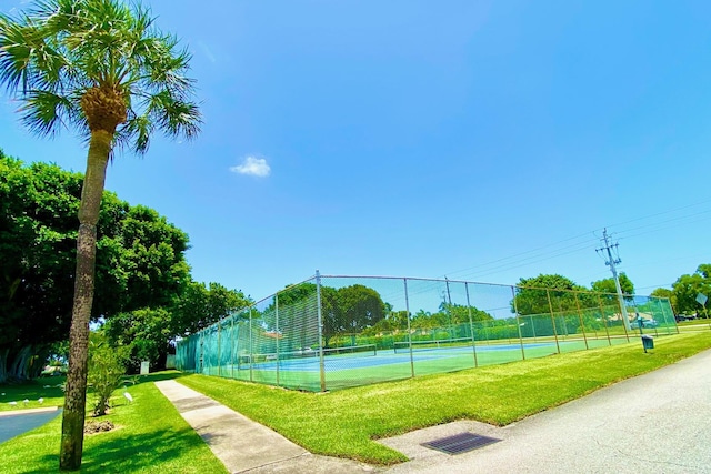 view of sport court featuring a lawn