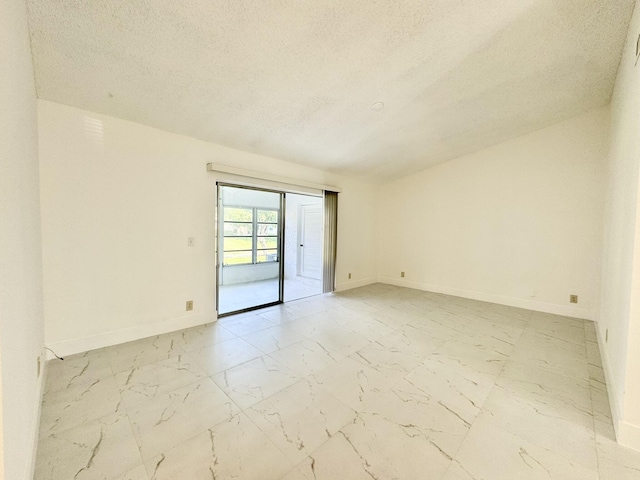 unfurnished room with a textured ceiling