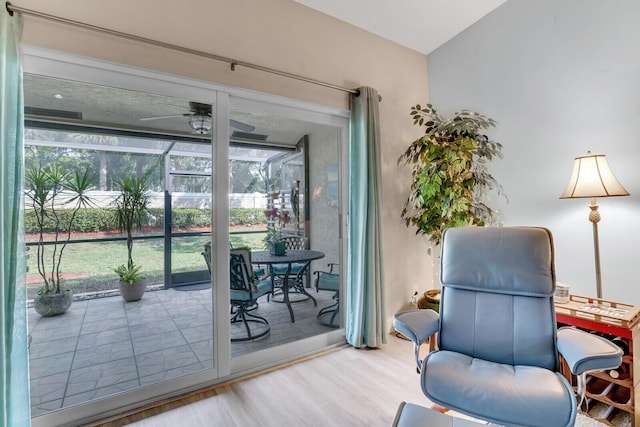 sitting room with a sunroom, ceiling fan, and wood finished floors